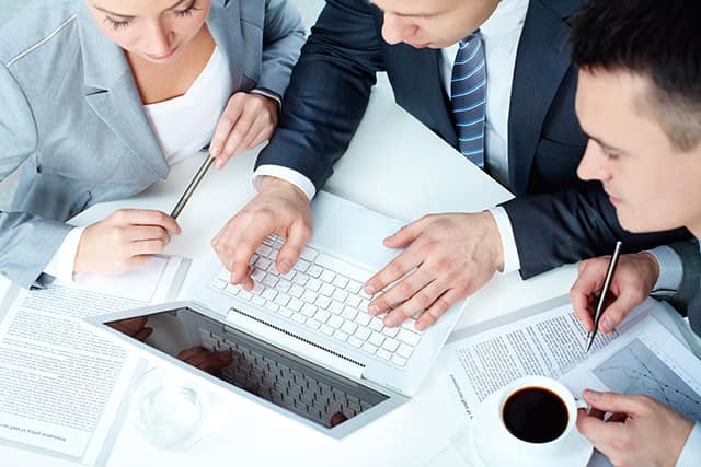 group of business people working with laptop at meeting