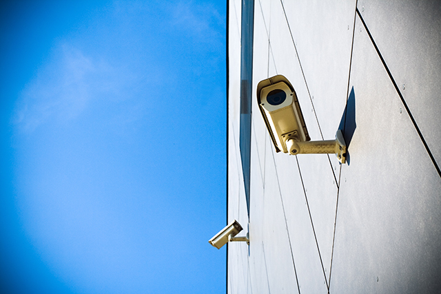 security camera over blue sky