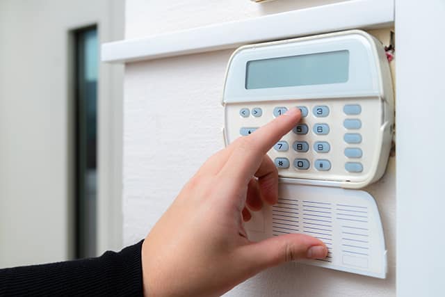 hand entering alarm system password of an apartment, home or bus hand entering alarm system password of an apartment, home or bus
