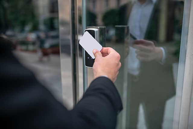 close up picture of mans hand holding an access card close up picture of mans hand holding an access card